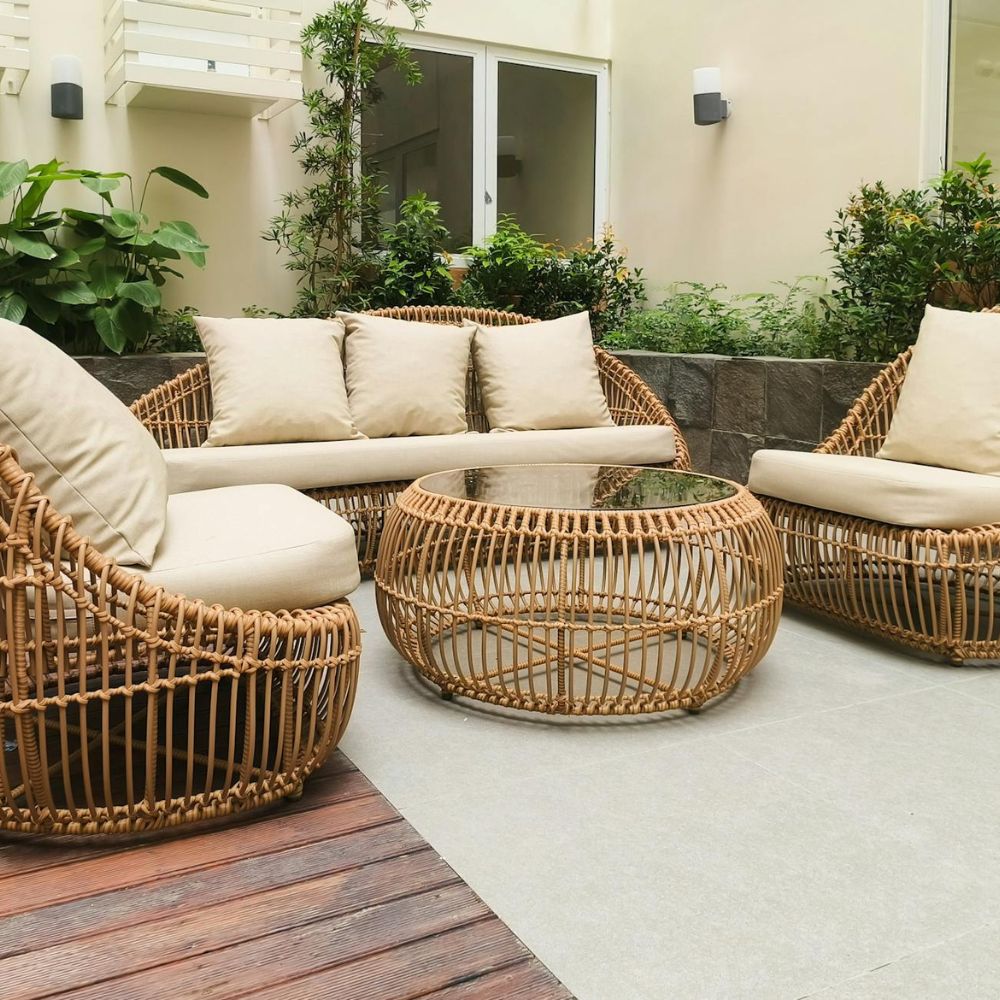 Outdoor patio with wicker furniture and beige cushions